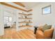 Comfortable sitting area with a leather chair, wooden floors and bespoke wooden shelving at 1452 S Washington St, Denver, CO 80210