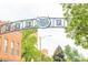 South Pearl Street sign over the street with trees and buildings in the background at 1452 S Washington St, Denver, CO 80210