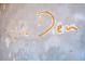 Close up of a Sushi Den sign on the wall, written in a creative and whimsical style at 1452 S Washington St, Denver, CO 80210