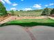 Enjoy a well-maintained backyard with a stone retaining wall, garden, wooden fence, and grassy area at 2180 Trailblazer Way, Castle Rock, CO 80109