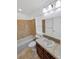 Bathroom with tile surround tub, dark vanity and tile flooring at 2180 Trailblazer Way, Castle Rock, CO 80109