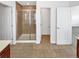 Bathroom featuring glass enclosed shower stall and tile flooring with access to toilet and bedroom at 2180 Trailblazer Way, Castle Rock, CO 80109