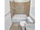 Bathroom with a tub/shower combination featuring tile surround, white toilet, and tile floors at 2180 Trailblazer Way, Castle Rock, CO 80109