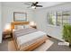 Cozy staged bedroom featuring a queen-sized bed, ceiling fan, and ample natural light at 2180 Trailblazer Way, Castle Rock, CO 80109