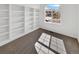 Bright bedroom features custom built-in shelving and a large window offering neighborhood views at 2180 Trailblazer Way, Castle Rock, CO 80109