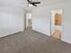 Bedroom with neutral carpeting, a closet, and a doorway leading to the bathroom at 2180 Trailblazer Way, Castle Rock, CO 80109
