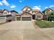 Charming two-story home with stone accents, three-car garage, and well-maintained landscaping at 2180 Trailblazer Way, Castle Rock, CO 80109