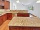 Gourmet kitchen boasts granite countertops, stainless appliances, custom island, and hardwood floors at 2180 Trailblazer Way, Castle Rock, CO 80109