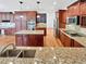 Gourmet kitchen with granite countertops, stainless appliances, custom cabinets, and hardwood floors at 2180 Trailblazer Way, Castle Rock, CO 80109