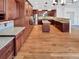 Gourmet kitchen with dark wood cabinets, stainless appliances, granite counters, and hardwood floors at 2180 Trailblazer Way, Castle Rock, CO 80109