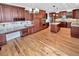 Spacious kitchen featuring custom cabinets, stainless steel appliances, and hardwood flooring at 2180 Trailblazer Way, Castle Rock, CO 80109