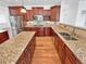 Spacious kitchen features granite countertops, dark wood cabinets, and stainless steel appliances at 2180 Trailblazer Way, Castle Rock, CO 80109