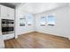 Sun-filled breakfast nook featuring large windows, hardwood floors, and built-in cabinets at 9324 Quartz St, Arvada, CO 80007