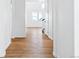 Bright hallway with hardwood floors leading to the upper level at 9324 Quartz St, Arvada, CO 80007