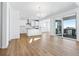 Open concept kitchen features white cabinets, stainless steel appliances, and an island at 9324 Quartz St, Arvada, CO 80007