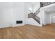 View of a living room with hardwood floors, fireplace, staircase, and modern design at 9324 Quartz St, Arvada, CO 80007
