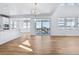 Spacious living room with a large sliding door, open floor plan, and hardwood floors at 9324 Quartz St, Arvada, CO 80007
