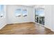 Open-concept living room with hardwood floors, large windows, and access to the outdoor deck at 9324 Quartz St, Arvada, CO 80007