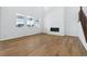 Bright living room with tall ceilings, large windows, fireplace, and wood flooring at 9324 Quartz St, Arvada, CO 80007