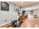Finished basement gym area with an elliptical machine and hardwood floors at 16341 Maple Rock Ct, Parker, CO 80134