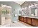 Stylish bathroom with a double vanity, decorative wall tiles, and sleek fixtures at 16341 Maple Rock Ct, Parker, CO 80134