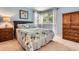 Comfortable bedroom with ample natural light and a decorative floral themed quilt at 16341 Maple Rock Ct, Parker, CO 80134