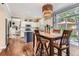 Dining area features wood floors, decorative lighting, and a sliding glass door with backyard access at 16341 Maple Rock Ct, Parker, CO 80134