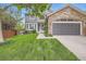 Charming two-story home with stone accents, lush lawn, and a well-maintained, inviting exterior at 16341 Maple Rock Ct, Parker, CO 80134