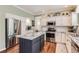 Well-lit kitchen with stainless steel appliances, granite countertops, and an island with bar seating at 16341 Maple Rock Ct, Parker, CO 80134