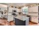 Charming kitchen featuring white cabinets, granite countertops, stainless steel appliances, and a center island at 16341 Maple Rock Ct, Parker, CO 80134