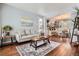 Bright living room featuring hardwood floors, neutral tones, and a seamless flow into the dining area at 16341 Maple Rock Ct, Parker, CO 80134