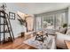 Cozy living room with hardwood floors, a comfortable couch, and ample natural light at 16341 Maple Rock Ct, Parker, CO 80134