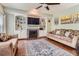 Inviting living room with a cozy fireplace, built-in shelves, hardwood flooring, and stylish decor at 16341 Maple Rock Ct, Parker, CO 80134