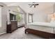 Spacious bedroom with large windows, soft carpet, and a dresser with a television for entertainment at 16341 Maple Rock Ct, Parker, CO 80134