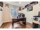 Functional office space with hardwood floors, a dark wood desk, and natural light at 16341 Maple Rock Ct, Parker, CO 80134