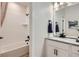 This bathroom features a shower and tub combo next to the double sink and vanity at 4108 Estrella St, Brighton, CO 80601
