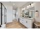This luxurious bathroom features double sinks, a walk-in shower, and a spacious layout at 4108 Estrella St, Brighton, CO 80601