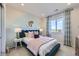 This tranquil bedroom features modern design, a large window, and carpeted floors for a cozy feel at 4108 Estrella St, Brighton, CO 80601