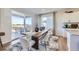 Bright dining area with a large window and sliding glass door that leads to an outdoor patio at 4108 Estrella St, Brighton, CO 80601