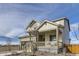 Inviting two-story home featuring a charming front porch and neutral-toned siding, complemented by well-maintained landscaping at 4108 Estrella St, Brighton, CO 80601