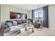 Unwind in this cozy living room, featuring a large window, comfortable seating, and stylish décor at 4108 Estrella St, Brighton, CO 80601