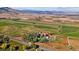 Aerial view of a property with a defined boundary, showcasing the house, trees, and open fields at 5101 Saint Vrain Rd, Longmont, CO 80503