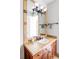 Bathroom with dark wooden cabinets, tile countertops, and a framed mirror over the sink at 5101 Saint Vrain Rd, Longmont, CO 80503