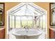 Luxurious bathroom with a soaking tub under skylight windows and stunning views at 5101 Saint Vrain Rd, Longmont, CO 80503