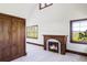 Bedroom featuring carpet, a fireplace, and two windows, offering a bright view of the outdoors at 5101 Saint Vrain Rd, Longmont, CO 80503