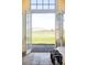 Bedroom view with French doors opening to a green field and distant mountains at 5101 Saint Vrain Rd, Longmont, CO 80503