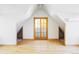 Bright bonus room with wood floors and natural light, featuring built-in shelving at 5101 Saint Vrain Rd, Longmont, CO 80503