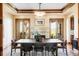 Formal dining room with fireplace, neutral colors, and French doors to outdoors at 5101 Saint Vrain Rd, Longmont, CO 80503