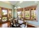 Dining area featuring a wood table, large windows, and natural lighting at 5101 Saint Vrain Rd, Longmont, CO 80503