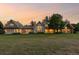 Sprawling home with a well-maintained lawn, large windows, and classic architectural details at sunset at 5101 Saint Vrain Rd, Longmont, CO 80503